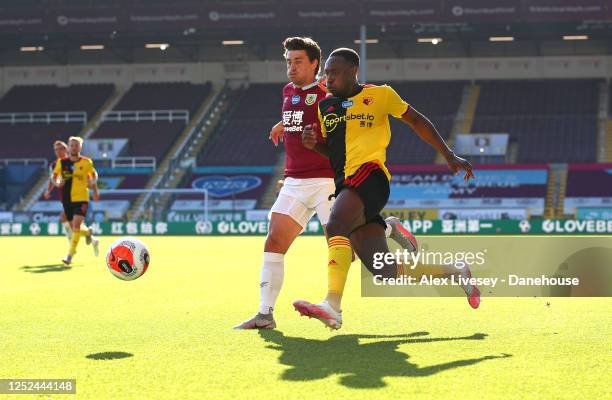 Danny Welbeck of Watford FC competes for the ball with Matthew Lowton of Burnley FC during the Premier League match between Burnley FC and Watford FC...