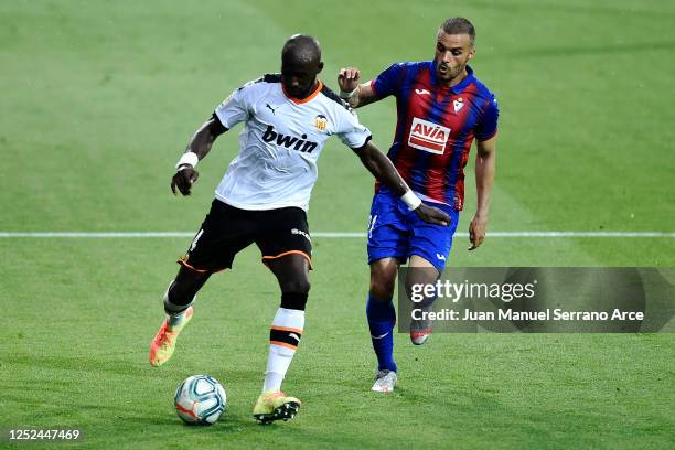 Eliaquim Mangala of Valencia CF battles for the ball with Pedro Leon of SD Eibar during the Liga match between SD Eibar SAD and Valencia CF at Ipurua...