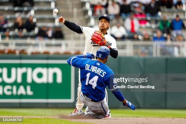 Edward Olivares of the Kansas City Royals is out at second base as Jorge Polanco of the Minnesota Twins turns a double play in the eighth inning at...