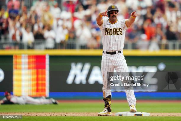 Matt Carpenter of the San Diego Padres celebrate after hitting a two-run double in the eighth inning during the game between the San Francisco Giants...