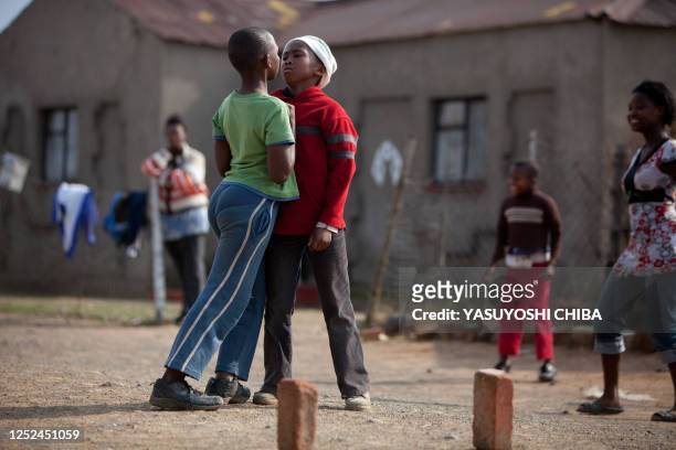 Children argue while playing football in a township a few hours before the Fifa Confederations Cup football match Spain vs South Africa on June 20,...