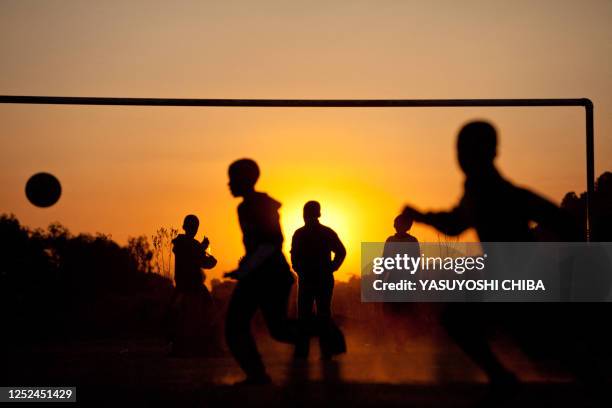 Children play football near Soccer City Stadium in Soweto, a suburb of Johannesburg on July 8, 2010. The Netherlands will clash with Spain in the...