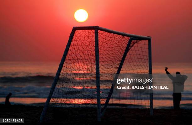 People visit the beach to catch the early morning sun at the North Pier Beach in Durban on June 25, 2010 before the 2010 World Cup Group G football...