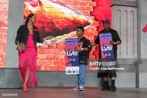 Two fans are presented with Super Bowl tickets during the third day of the NFL Draft on April 29, 2023 at Union Station in Kansas City, MO.
