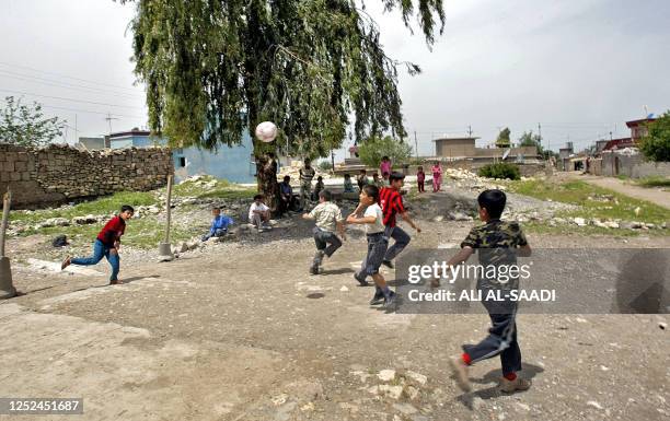 Iraqi Kurdish children play in one of the streets of the northern Iraqi city of Halabja, 08 May 2006. An X-ray of Kamil Abdel Qader's lungs show a...