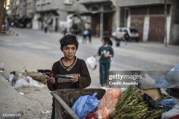 Year-old, Palestinian boy named Hasan Abu Emune collects recyclable material such as, paper, metal and glass to contribute his family's livelihood as...