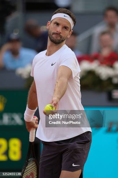 Grigor Dimitrov of Bulgaria plays against Carlos Alcaraz of Spain during their third round match on day seven of the Mutua Madrid Open at La Caja...