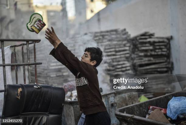 Year-old, Palestinian boy named Hasan Abu Emune collects recyclable material such as, paper, metal and glass to contribute his family's livelihood as...