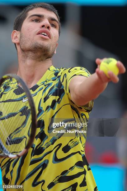 Carlos Alcaraz of Spain against Grigor Dimitrov of Bulgaria during their third round match on day seven of the Mutua Madrid Open at La Caja Magica on...