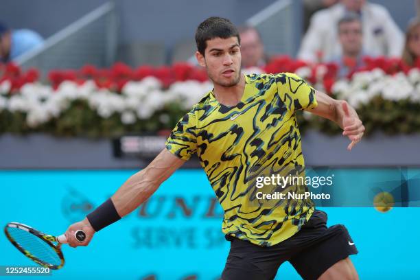 Carlos Alcaraz of Spain against Grigor Dimitrov of Bulgaria during their third round match on day seven of the Mutua Madrid Open at La Caja Magica on...