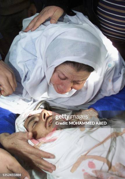 The mother of Palestinian Abdel Fatah Mansour kisses her son who was shot dead by Israeli soldiers in the southern Gaza Strip town of Rafah 18...