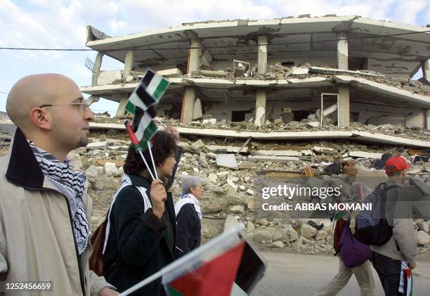 Anti-globalisation activists take part in a demonstration against the Israeli occupation in front of Palestinian leader Yasser Arafat's headquarters...