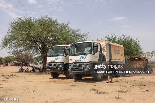 Trucks from the World Food Program (WFP are parked near temporary shelters for Sudanese refugees from the Tandelti area who crossed into Chad, in...
