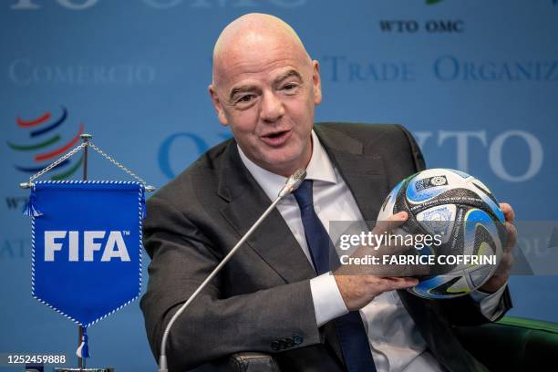 President Gianni Infantino holds an official ball of the 2023 FIFA Women's World Cup during the "Making trade score for women!" discussion on the use...