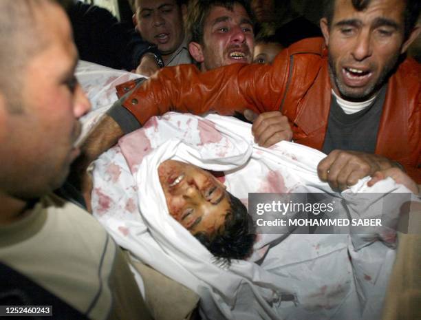 The father of thirteen-year-old Thaer Rihan holds onto his son during to his funeral at his home in the Jabalia refugee camp, north of Gaza City 06...