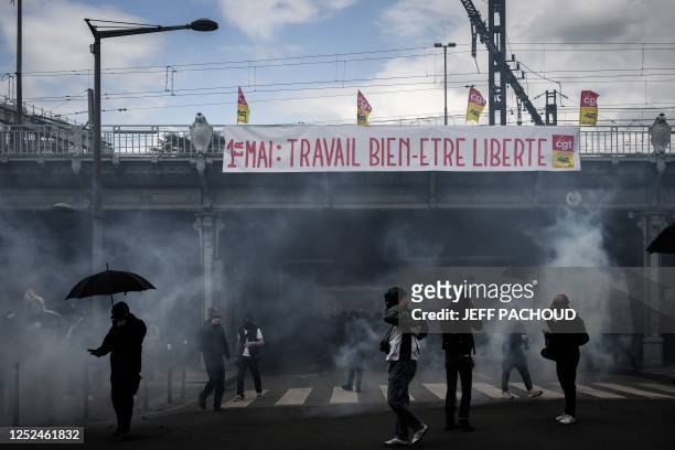 Protesters walk in a cloud of teargas as they take part in a demonstration on May Day , to mark the international day of workers, more than a month...