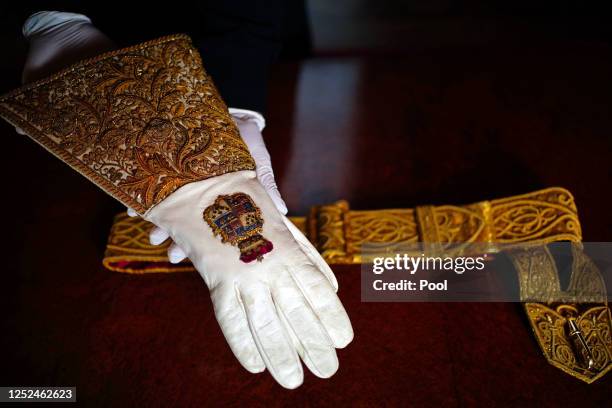 The Coronation Gauntlet glove and Sword Belt, which form part of the Coronation Vestments, are displayed in the Throne Room at Buckingham Palace on...