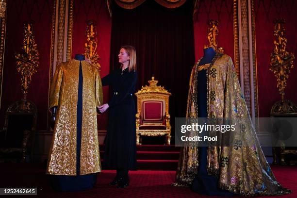 Caroline de Guitaut, deputy surveyor of the King's Works of Art for the Royal Collection Trust, adjusts the Coronation Vestments, comprising of the...