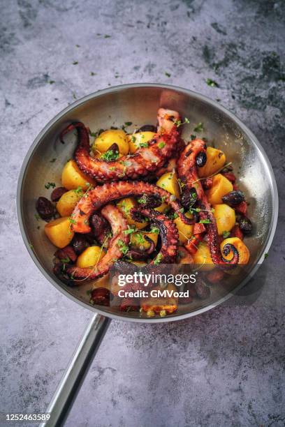 octopus tentacles with potatoes and fresh lemon - squid stock pictures, royalty-free photos & images