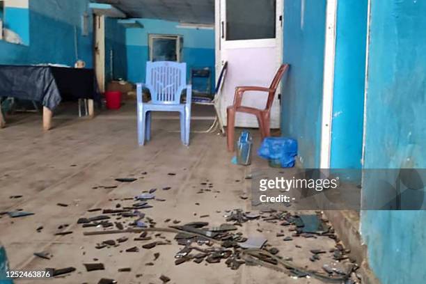 Picture taken on May 1, 2023 shows shattered glass inside an abandoned hospital in El Geneina, the capital of West Darfur, as deadly fighting...
