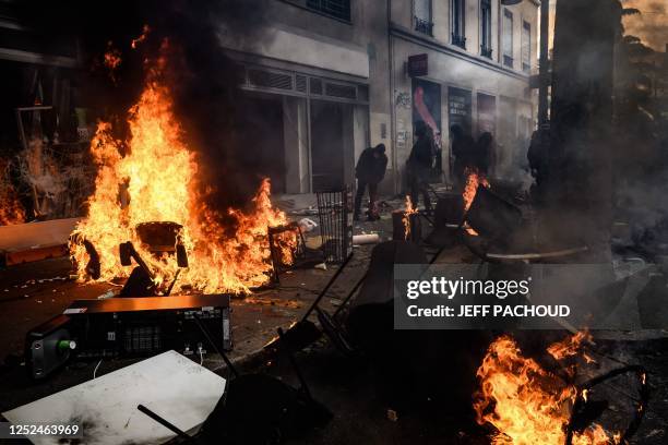 Flames emerge from furniture burning in the street during a demonstration on May Day , to mark the international day of workers, more than a month...