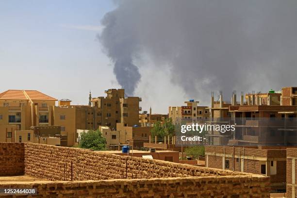 Smoke billows over residential buildings in Khartoum on May 1, 2023 as deadly clashes between rival generals' forces have entered their third week. -...