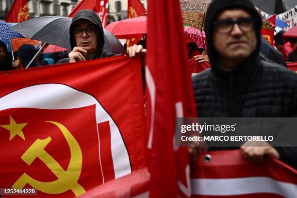Protestors hold the flag of communist party during a demonstration on May Day , to mark the international day of the workers, in Turin on May 1, 2023.