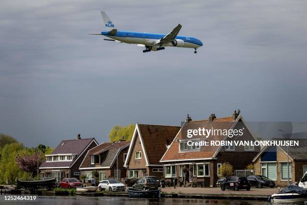 Boeing 777-306 aircraft from KLM flies over residences in the vicinity of Schiphol Airport, on the outskirts of Amsterdam on May 1, 2023. Several...