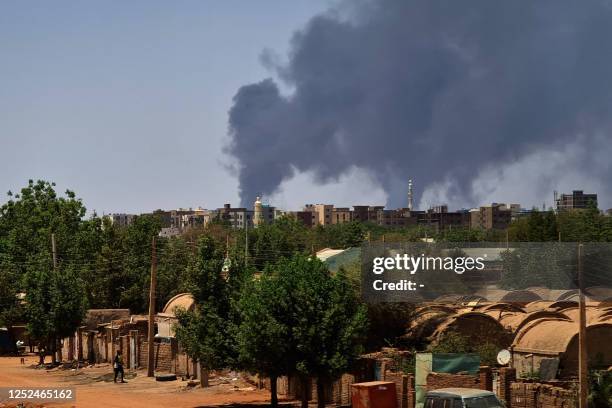 Smoke billows over buildings in Khartoum on May 1, 2023 as deadly clashes between rival generals' forces have entered their third week. - The top...