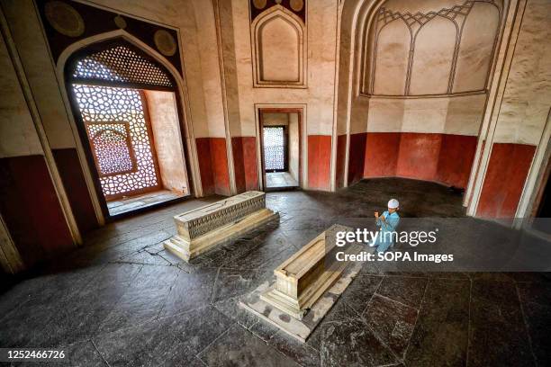 Kid offers prayers inside the Humayun Tomb in New Delhi. Humayun's Tomb is a grand dynastic mausoleum that was to become synonyms of Mughal...