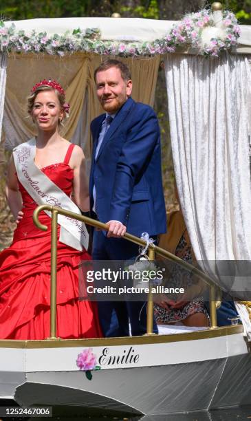 May 2023, Saxony, Gablenz: Michael Kretschmer , Prime Minister of Saxony, and Kromlau's Blossom King Stefanie Engler ride the newly christened...