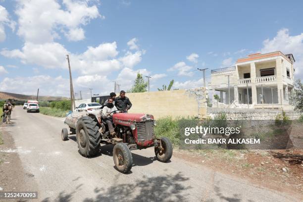 Man drives past a house reportedly used by suspected leader of the Islamic State group Abu Hussein al-Qurashi, on May 1 in the village of Maska,...