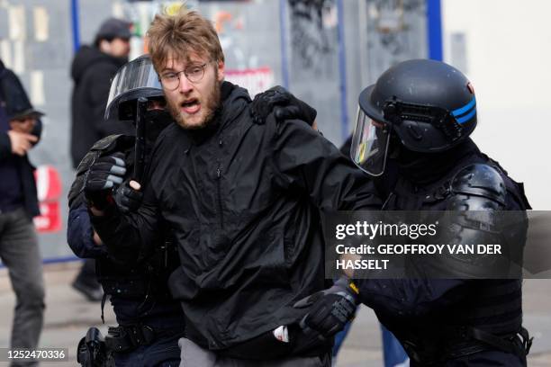 Police officers detain a protester during clashes as part of a demonstration on May Day , to mark the international day of the workers, more than a...