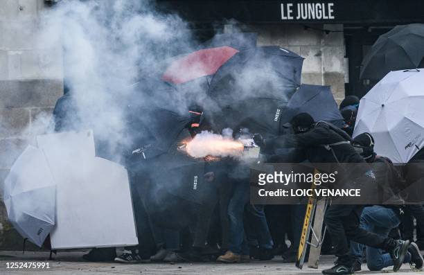 Protestor fires fireworks as they clash with riot police during a demonstration on May Day , to mark the international day of workers, more than a...