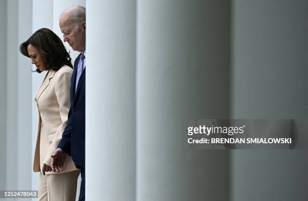Vice President Kamala Harris and US President Joe Biden arrive to deliver remarks during National Small Business Week, in the Rose Garden of the...