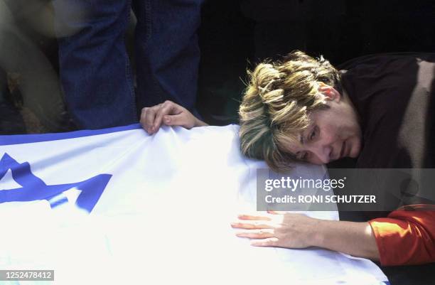 Ruti mourns at the coffins of her son Tom and her former husband Mordechai Hershko during their funeral in Haifa 07 March 2003. The two were among...