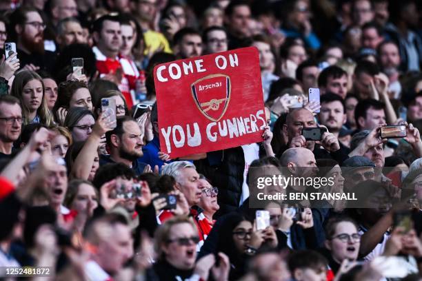 Arsenal's fans hold a banner as they cheer for their team during the UEFA Women's Champions League semi-final second-leg match between Arsenal and...