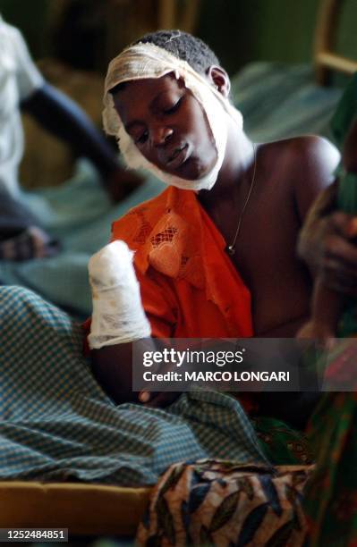 Neema lies in her hospital bed in Drodro, DRCongo, after her hand was chopped off during the April 03 attack 08 April 2003. About 1,000 members of...