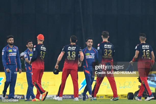 Royal Challengers Bangalore's players greet Lucknow Super Giants' players at the end of the Indian Premier League Twenty20 cricket match between...