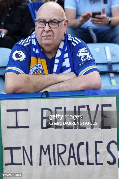 Leicester City's fan sits behind a board cheering for his team during the English Premier League football match between Leicester City and Everton at...