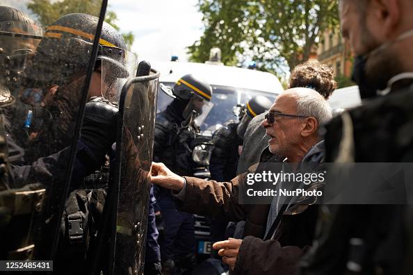 Mancatcher Riot Police A man tries to push back a riot policeman. For May Day or Labour Day ...