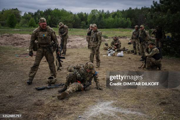 Ukrainian servicemen take part in battlefield first aid training during a military exercise in the Kharkiv region on May 1 amid the Russian invasion...