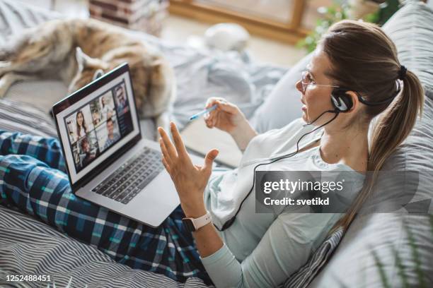 working from bed during pandemic - pajamas stock pictures, royalty-free photos & images