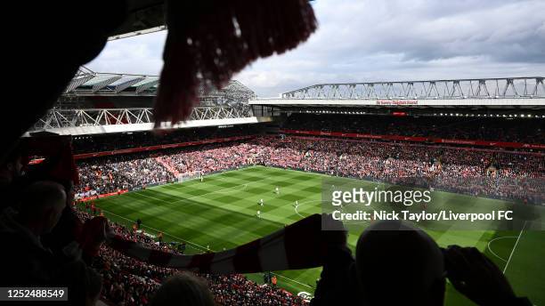 Liverpool fans raise their scarves to sing "You'll Never Walk Alone" as the teams on the pitch prepare for kick-off during the Premier League match...