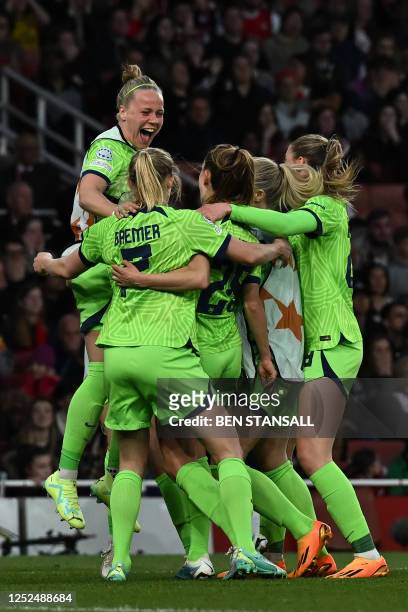 Wolfsburg's German forward Pauline Bremer celebrates with teammates after scoring her team third goal during the UEFA Women's Champions League...