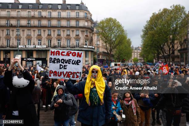 People demonstrate on the streets as this year's May Day protests coincide with weeks of public outrage over a pension-reform law that increased the...