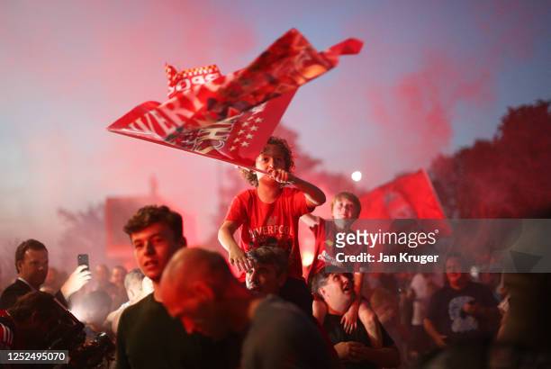 Liverpool fans celebrate as their team clinches the Premier League title at Anfield on June 25, 2020 in Liverpool, England. Liverpool are crowned...