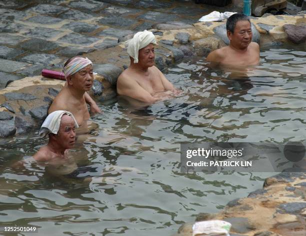 Group of Taiwan people soak in an outdoor Kurhaus located in Peitou, a popular hot spring spot off Taipei, 06 March, 2006. Japan's "onsen" culture...