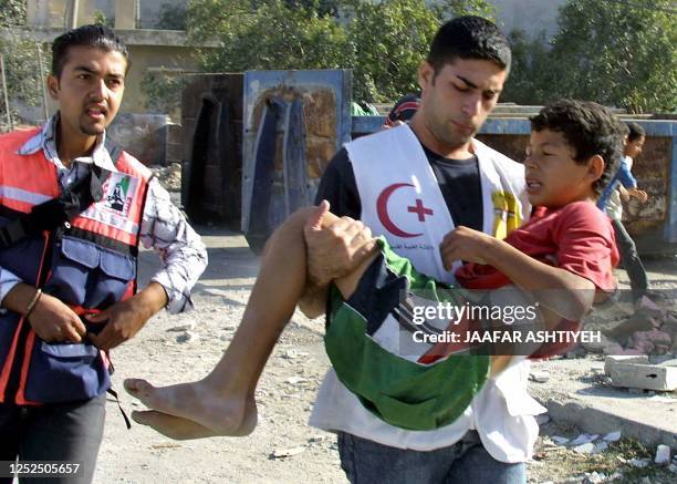 An injured Palestinian boy is carried away after he wounded during clashes with Israeli soldiers following army operation at the El Ein refugee camp...