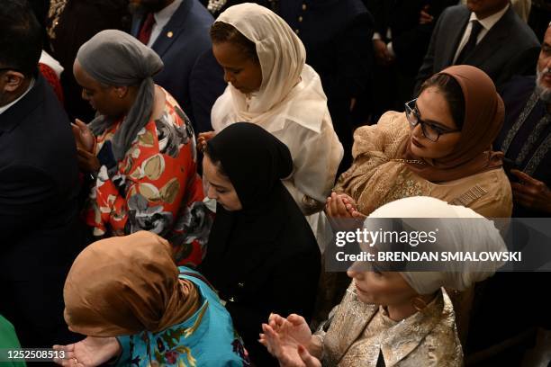 Women pray as US President Joe Biden hosts a reception celebrating Eid al-Fitr, marking the end of the Muslim fasting month of Ramadan, in the East...